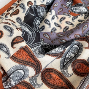 Close-up of paisley pattern cotton linen scarf with orange and purple patchwork design