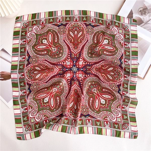 Detail of silk-feel square scarf with classic red and green paisley bohemian patterns