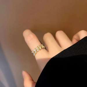Elegant gold leaf ring with marquise-cut cubic zirconia worn on finger
