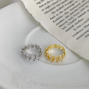 Detail of adjustable leaf rings with marquise zircons in gold and silver finish