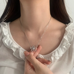 Elegant silver openwork flower pendant necklace with shimmering cubic zirconia accents