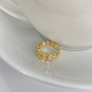 Detailed close-up of a gold leaf ring with sparkling marquise-cut zircon stones