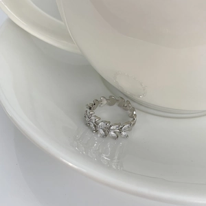 Detailed close-up of leaf-shaped silver ring with sparkling marquise-cut zircon stones