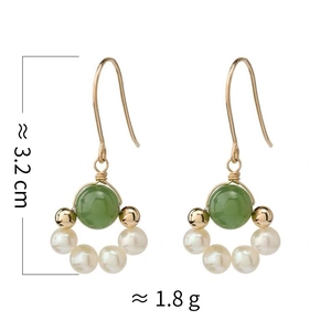 Detail view of gold-plated drop earrings with green jade beads and freshwater pearls