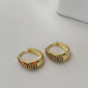 Detail view of gold hoop earrings with colorful micro-pave cubic zirconia stones