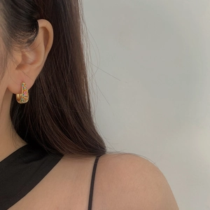 Minimalist gold plated hoop earrings with multicolored cubic zirconia worn by model