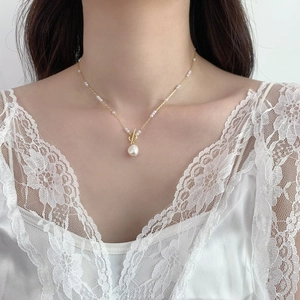 Baroque pearl necklace with golden OT buckle and dainty pearls on a female model