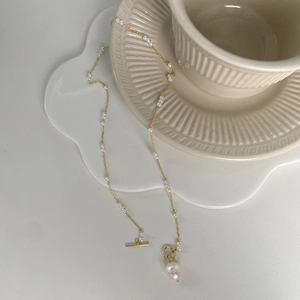 Detail of freshwater pearl necklace with gold OT clasp and large baroque pearl pendant