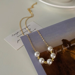 French vintage pearl necklace with five white beads on a 14k gold-plated chain
