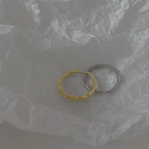 Macro detail of minimalist gold and silver rings with unique irregular hammered texture