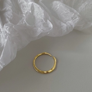 Detailed view of gold plated adjustable ring featuring a unique hammered metal texture