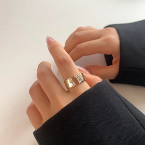 Minimalist gold plated adjustable ring featuring geometric cubic zirconia accents on hand