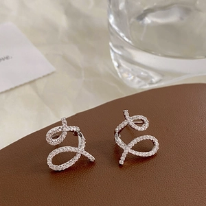 Elegant spiral pavé zirconia crossover earrings in silver finish on leather base
