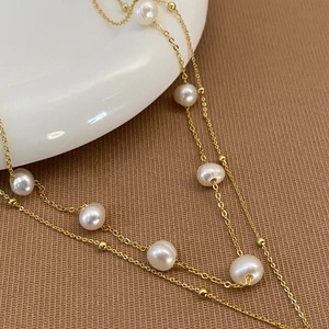 Detail of double-layer natural freshwater pearl necklace with gold-plated copper chain