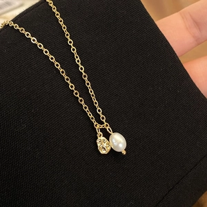 Elegant gold plated necklace featuring a molten pendant and natural freshwater pearl