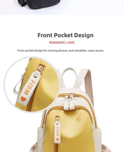 Detail of yellow and white nylon backpack featuring front zipper pocket and FIDM strap