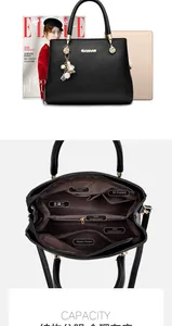 Dettaglio degli scomparti interni di una grande borsa tote in pelle nera da donna
