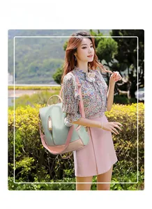 Outdoor shot of mint green and pink water-resistant nylon backpack with side pockets