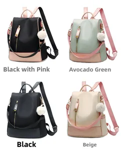 Detail view of water-resistant oxford backpacks in four candy colors with pompom charms