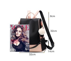 Detailed size chart of a black and pink waterproof nylon backpack with white pompom charm