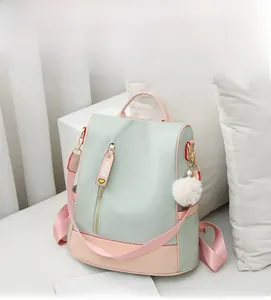 Detail of pink and green waterproof backpack with FIDM strap on white sofa background