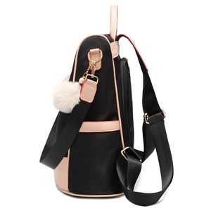 Waterproof black nylon backpack with beige trim and soft faux fur pompom charm detail