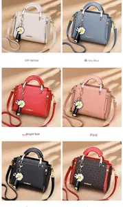 Detail of trendy tote bags in six colors with leather texture and daisy charm