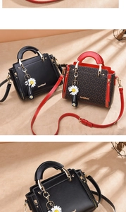 Detail view of stylish handbags with metal ring handles and elegant daisy charms
