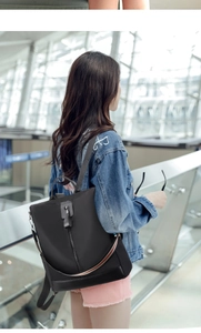 Detail of waterproof black nylon backpack with multi-functional straps for travel use