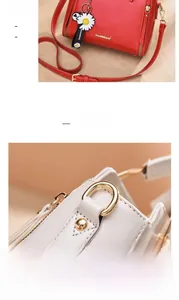 Close-up of gold-plated D-ring hardware on a stylish red leather women's handbag
