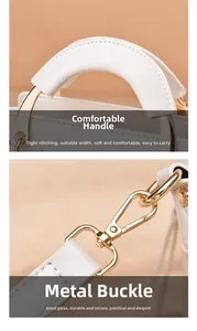 Detailed view of quilted leather handle and premium gold metal hardware on the white bag