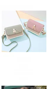 Detail view of envelope bags with cat-ear gold locks and letter-print wide straps