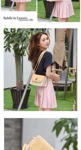Detail showing elegant beige and yellow leather crossbody bag with metal chain strap