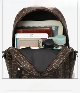 Internal multi-layer structure of monogram backpack showing iPad and wallet storage