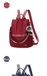 Detailed view of waterproof oxford fabric backpacks in wine red and blue colors