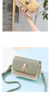 Close-up of contrast crossbody bag with cat metal buckle and wave stitching detail