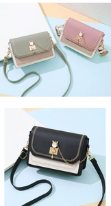 Detail of trendy crossbody bags featuring cat ear metal locks and stylish stitching
