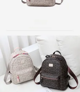 Detail of fashion mini backpack featuring FIDM letter print and metal logo plate