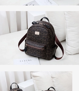 Detail of dark brown leather backpack featuring all-over FIDM letter print and front zipper