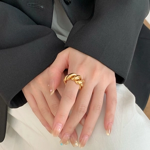 Polished gold croissant dome ring with a vintage twisted rope design worn on finger