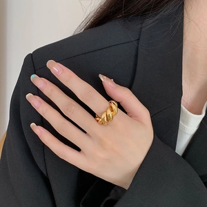 French vintage gold twisted croissant ring with minimalist textured finish on model