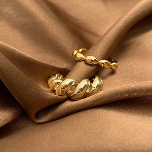 French vintage gold twisted rope and beaded ring set on elegant brown silk background