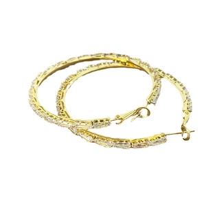 Elegant gold hoop earrings with baguette-cut sparkling crystals on white background