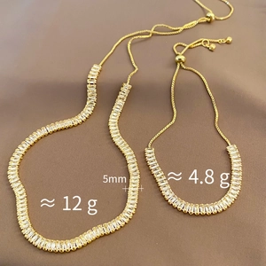 Detail of adjustable gold-plated bracelet and necklace set with baguette-cut zircons