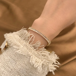 Detail of adjustable gold-plated bracelet featuring rectangular pavé zircon stones