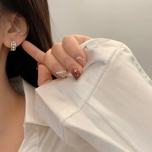 Close-up of hoop earrings with pearls and pavé cubic zirconia on model's ear