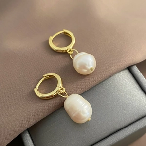 Detailed close-up of French vintage drop earrings with freshwater pearls and gold-plated hoops