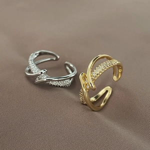 Detail of interlocking silver and gold rings featuring micro-pave cubic zirconia accents