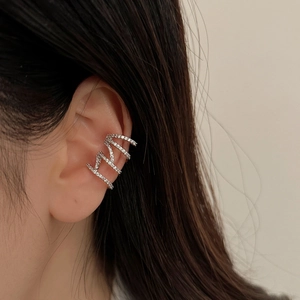 Elegant multi-layer silver ear cuff with sparkling cubic zirconia on a female model
