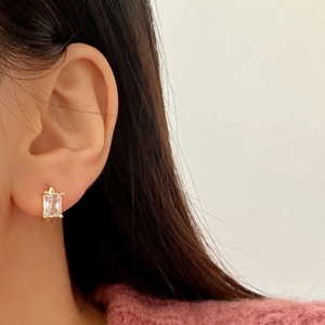 Elegant gold-plated hoop earrings with rectangular cubic zirconia shown on model